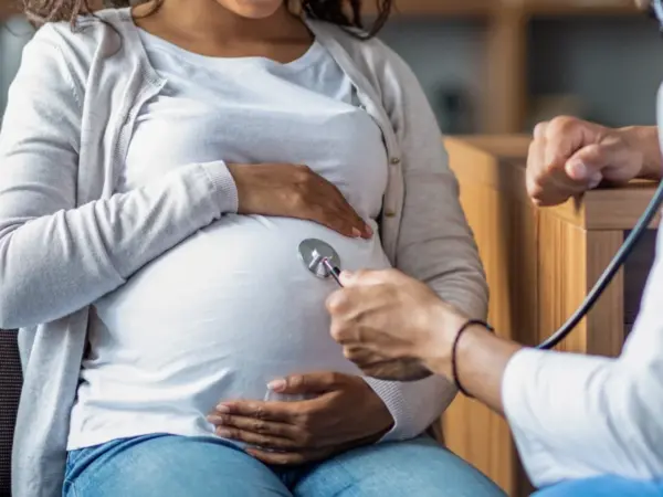 pregnant black woman with doctor