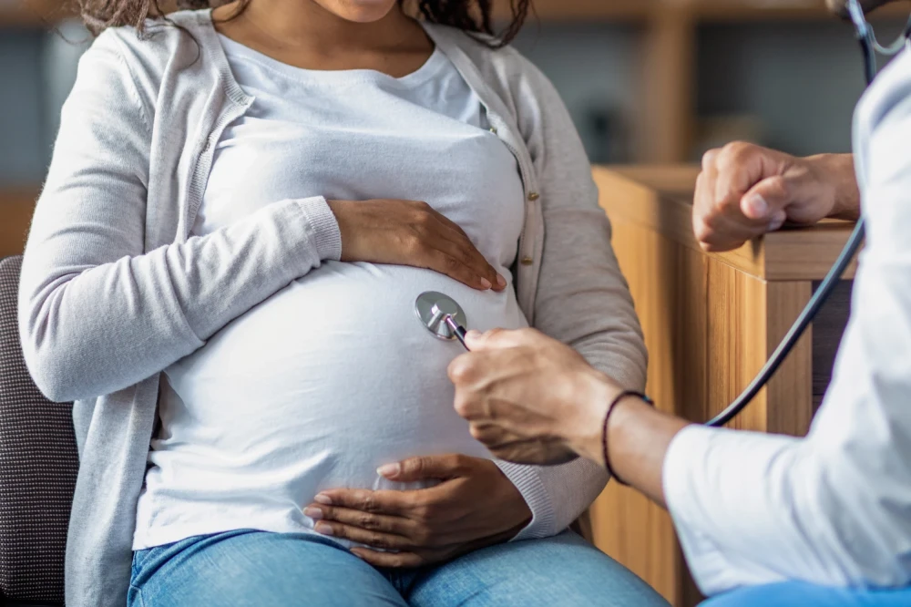 pregnant black woman with doctor pregnant black woman with doctor