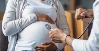 pregnant black woman with doctor